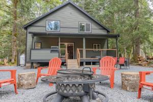 a tiny house with a table and chairs in front of it at Luxe Chalet at Rainier Entrance with Hot Tub-AC-WiFi in Ashford