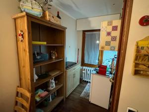 a kitchen with a counter and a refrigerator in a room at Sestriere monolocale in Sestriere