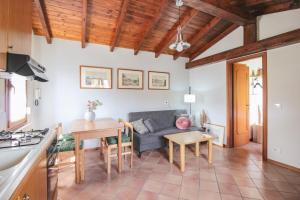 a kitchen and living room with a couch and a table at Villa Sanziana in Menaggio