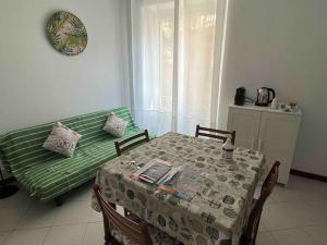 a dining room with a table with a green table cloth at Andromeda Holiday 1 C in Genoa
