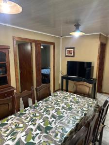 a dining room with a table and a bed with at Casa Madison in Casa Grande