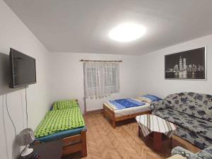 a room with two beds and a flat screen tv at Holiday home in Siofok - Balaton 51864 in Siófok