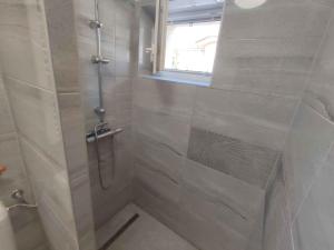 a shower with a glass door in a bathroom at Holiday home in Siofok - Balaton 51864 in Siófok +7 photos