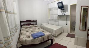 Postel nebo postele na pokoji v ubytování Hotel Santos Reis