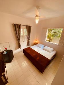 a bedroom with a bed and a window at Adios Amigos Hostel in Arraial d'Ajuda +39 photos
