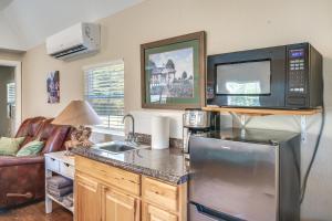 a kitchen with a sink and a microwave at Plantersville Cabin on 50 Acres with Pond and Fire Pit in Magnolia