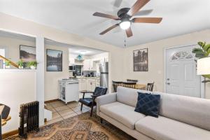 a living room with a couch and a ceiling fan at Modern Mountain Cottage w Hot Tub, Fire Pit, WiFi in Inwood