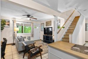 a living room with a couch and a tv at Modern Mountain Cottage w Hot Tub, Fire Pit, WiFi in Inwood