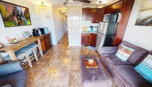 a living room with a couch and a kitchen at Beachfront View Condo at Casa Del Mar in Galveston