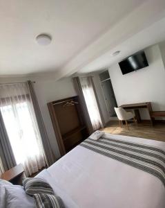 Postel nebo postele na pokoji v ubytování Hotel Rumi