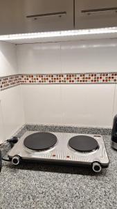 a stove top on a counter in a kitchen at Presidenziale apartamento in San Francisco +9 photos