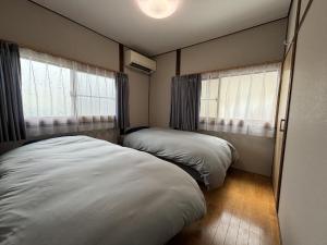 A bed or beds in a room at コリーヌ小山