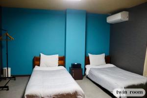 Vuode tai vuoteita majoituspaikassa GUESTHOUSE富士と碧