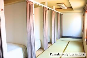 Vuode tai vuoteita majoituspaikassa GUESTHOUSE富士と碧