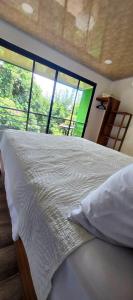 Una cama o camas en una habitación de Sunshine Sanctuary Boutique Jungle Lodge
