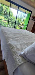 Una cama o camas en una habitación de Sunshine Sanctuary Boutique Jungle Lodge