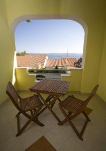 a table and two chairs on a balcony with a view at Apartments Rubic in Omiš
