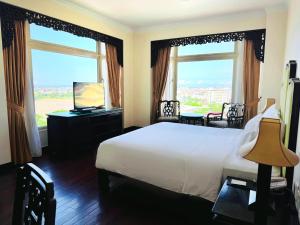 Postel nebo postele na pokoji v ubytování TTC Imperial Hotel