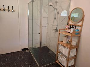 a bathroom with a shower with a mirror and a shelf at Auyea Farm 3BR Entire House - 7 Mins to Gumbuya World in Tynong North +28 photos