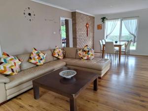 a living room with a couch and a table at Auyea Farm 3BR Entire House - 7 Mins to Gumbuya World in Tynong North
