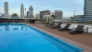 a swimming pool on the roof of a building at Pearl Manila Hotel in Manila