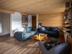 a living room with two couches and a table at Chalet spacieux 12 pers, 4 ch, 4 sdb, cuisine équipée, parking, cheminée - FR-1-676-201 in La Chapelle-dʼAbondance