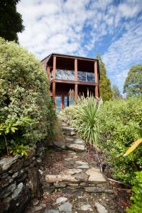 a house on a hill with a stone path at Kauri House Apartment in Wanaka