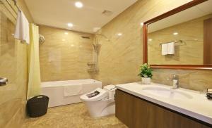 Un baño con lavabo, inodoro y espejo. en BEU Home Tay Ho, en Hanói 23 fotos más
