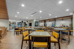 a dining room with tables and yellow chairs at Fairfield by Marriott Inn & Suites North Conway in North Conway