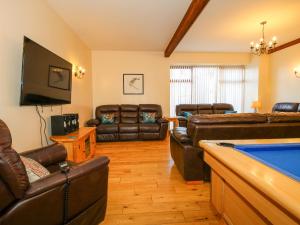 a living room with couches and a pool table at The Mill House in Shrewsbury