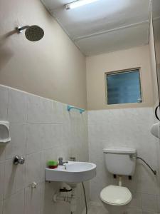 a bathroom with a toilet and a sink at Rawang HoBudjet Homestay in Rawang +13 photos