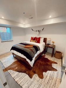 a bedroom with a large bed with a large rug at The Cowboy Inn - Luxury Bozeman in Bozeman