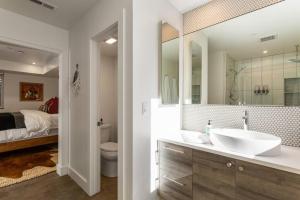 a bathroom with a sink and a toilet and a bed at The Cowboy Inn - Luxury Bozeman in Bozeman +42 photos