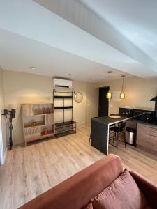 a living room with a couch and a kitchen at Maison à la campagne in Bons-Tassily