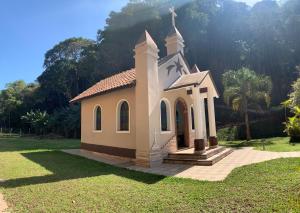 a small chapel in the middle of a field at Casa de Campo vista para o Lago em Juquitiba SP in Juquitiba