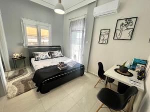 a bedroom with a bed and a table and chairs at 4SeasonsApartment in Karditsa