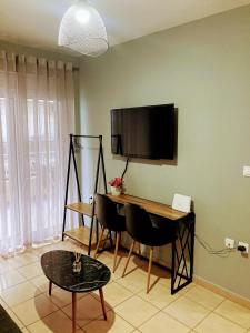 a room with a desk and a television on a wall at M.O.M.’s in Alexandroupoli +75 photos