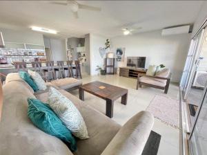 a living room with a couch and a table at VayKZN Umdloti in Umdloti