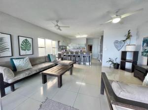 a living room with a couch and a table at VayKZN Umdloti in Umdloti