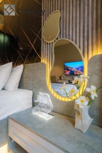 a bedroom with a bed with a mirror and a table at Cubicity Wall Street House in Ho Chi Minh City