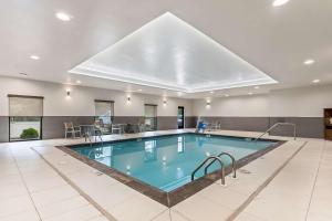a large swimming pool with a large skylight at Comfort Suites in Columbia