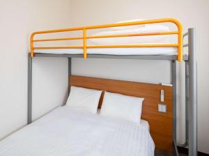 a bedroom with two bunk beds in a room at Comfort Inn Zentsuji Inter in Marugame