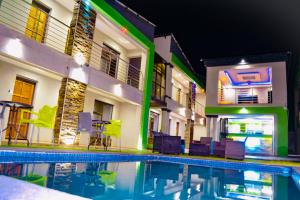 a swimming pool in front of a building at night at Debreeze guest lodge in Malelane +43 photos