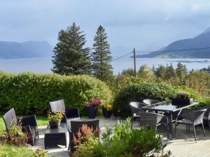 a patio with chairs and a table with a view of the water at 6 person holiday home in Åram-By Traum in Sandvik