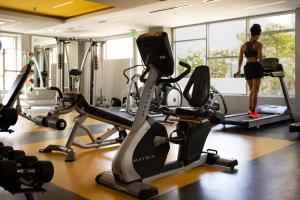 a woman standing in a gym with cardio machines at Bright lights central Downtown in Los Angeles