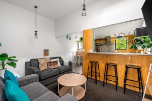 a living room with a couch and a bar at 2 minutes to town! No car needed! Compact and Warm in Queenstown