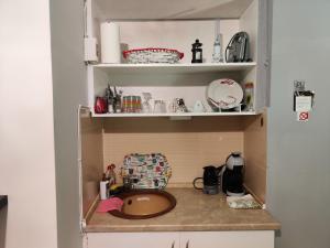 a kitchen counter with a sink in a cabinet at Ονειροπαγίδα in Veria +14 photos