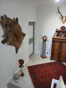 a living room with a room with a red rug at Ferienwohnung im alten Forstamt in Erndtebrück