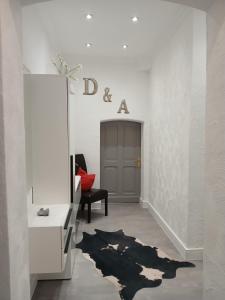 a white room with a mirror and a chair at Ferienwohnung im alten Forstamt in Erndtebrück