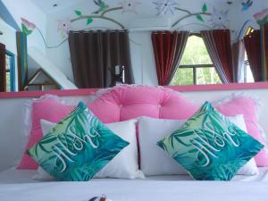 a bunch of pillows on top of a bed at MG CHATEAU RESORT Grand Suites in Nacpan